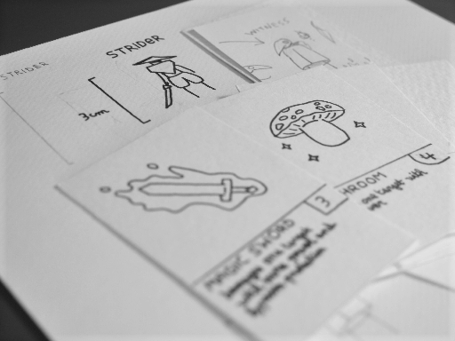 [A photo of some sketches for a card game, made on paper.]