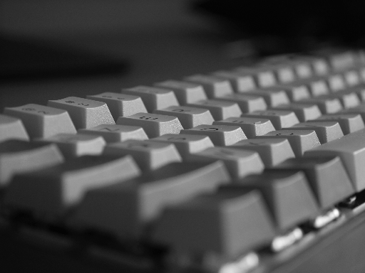 [A close-up photo of a keyboard mounted in a grey 3D-printed case.]